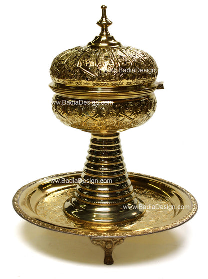 Decorative brass incense burner with intricate designs on a white background