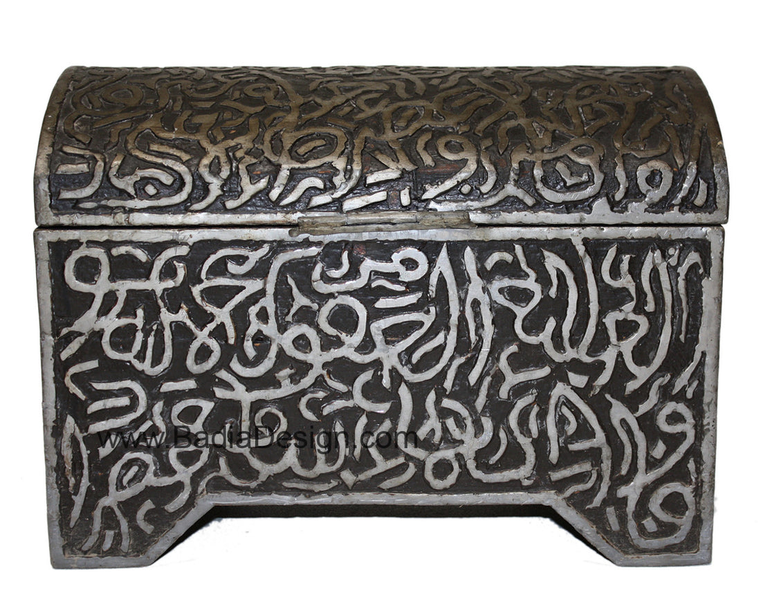 Decorative metal box with intricate carvings and Arabic calligraphy on a white background
