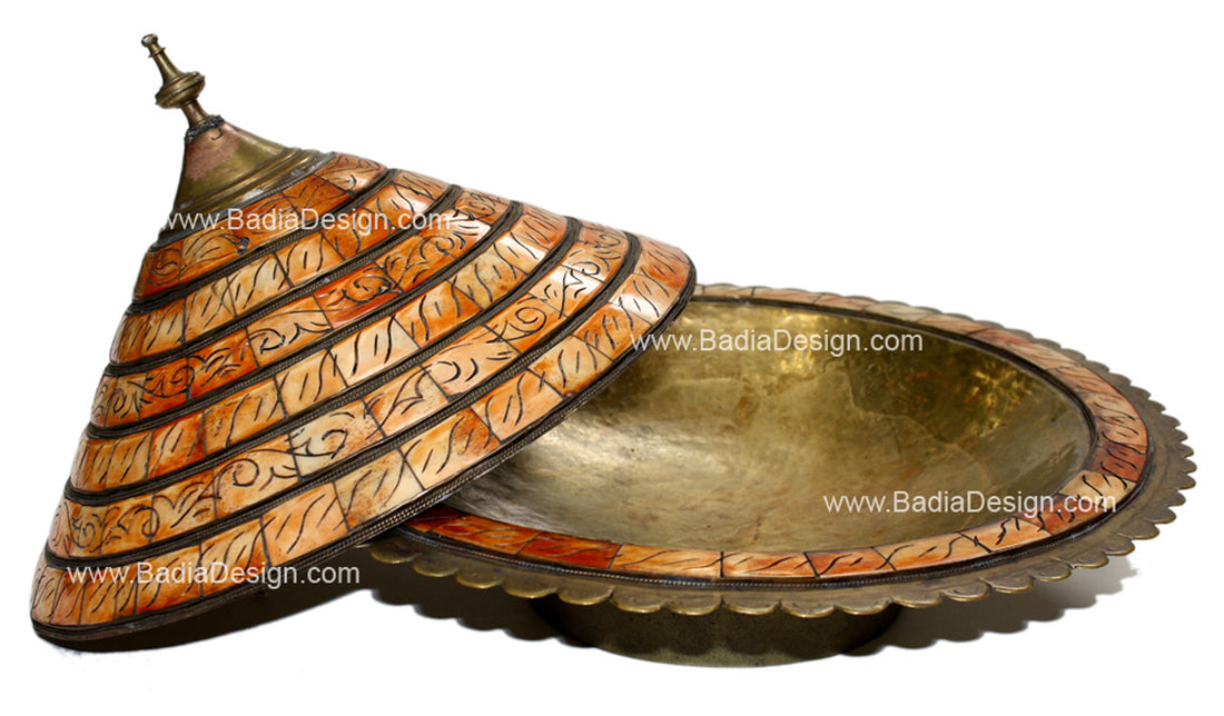 Decorative metal box with intricate designs on a white background
