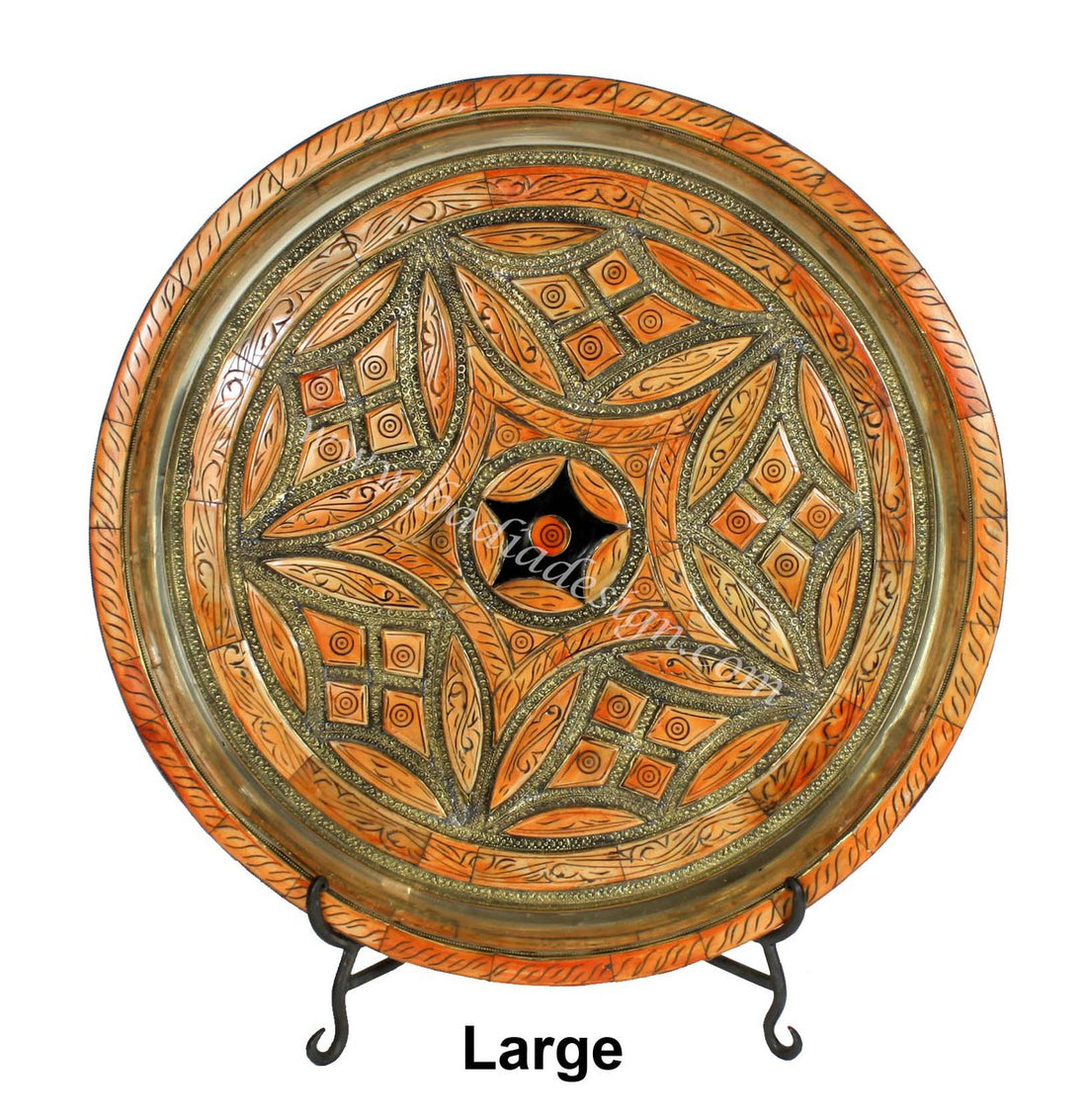 Decorative large plate with intricate patterns on a stand against a white background