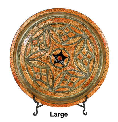 Decorative large plate with intricate patterns on a stand against a white background