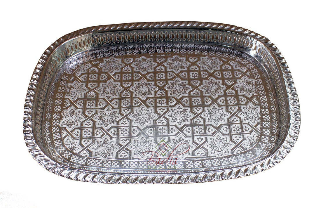 Decorative metal tray with intricate patterns on a white background