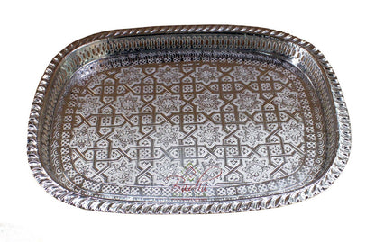 Decorative metal tray with intricate patterns on a white background