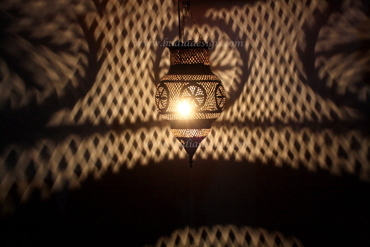 Decorative hanging lamp casting shadows on a textured wall