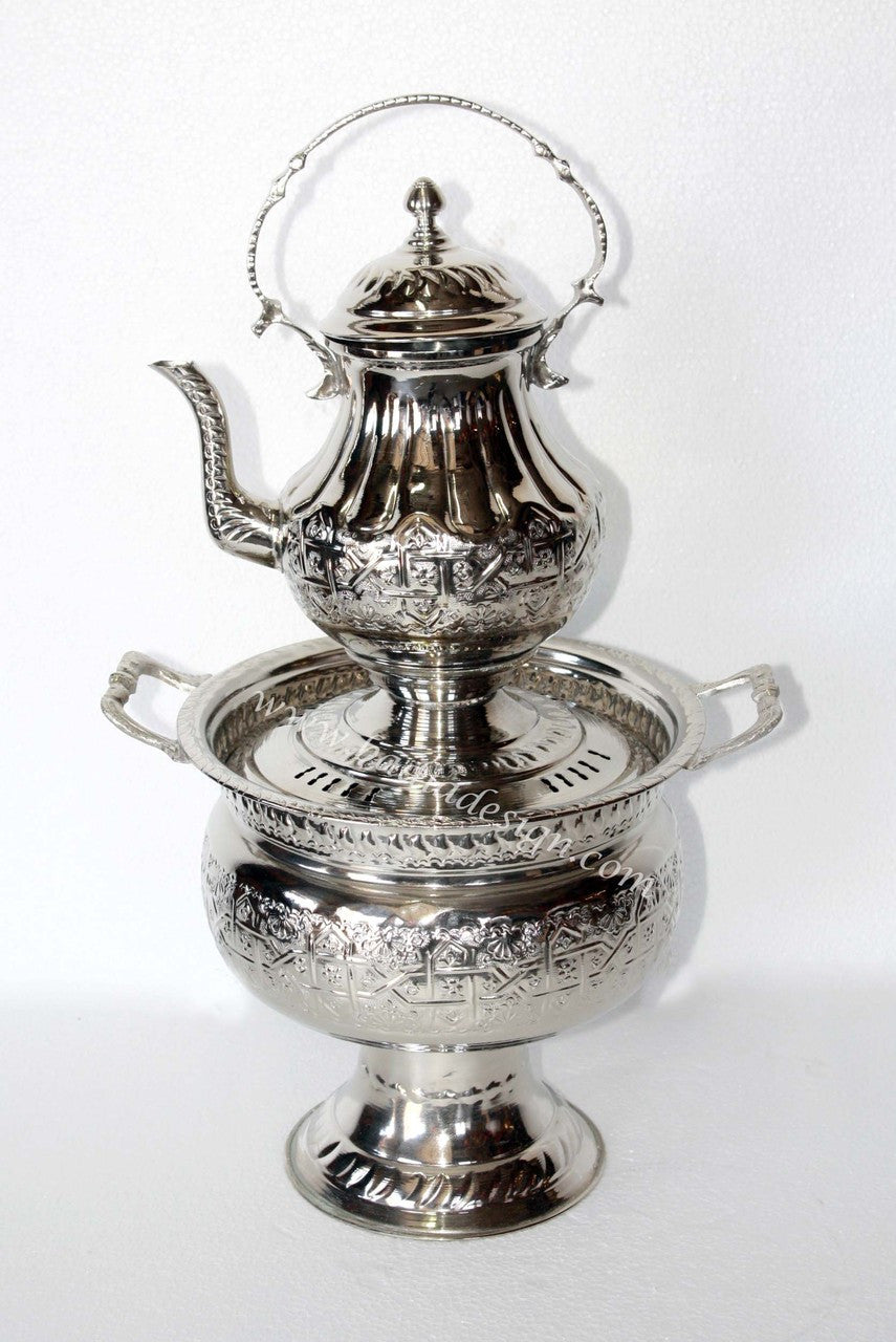 Silver tea set with a teapot and matching teacup on a white background