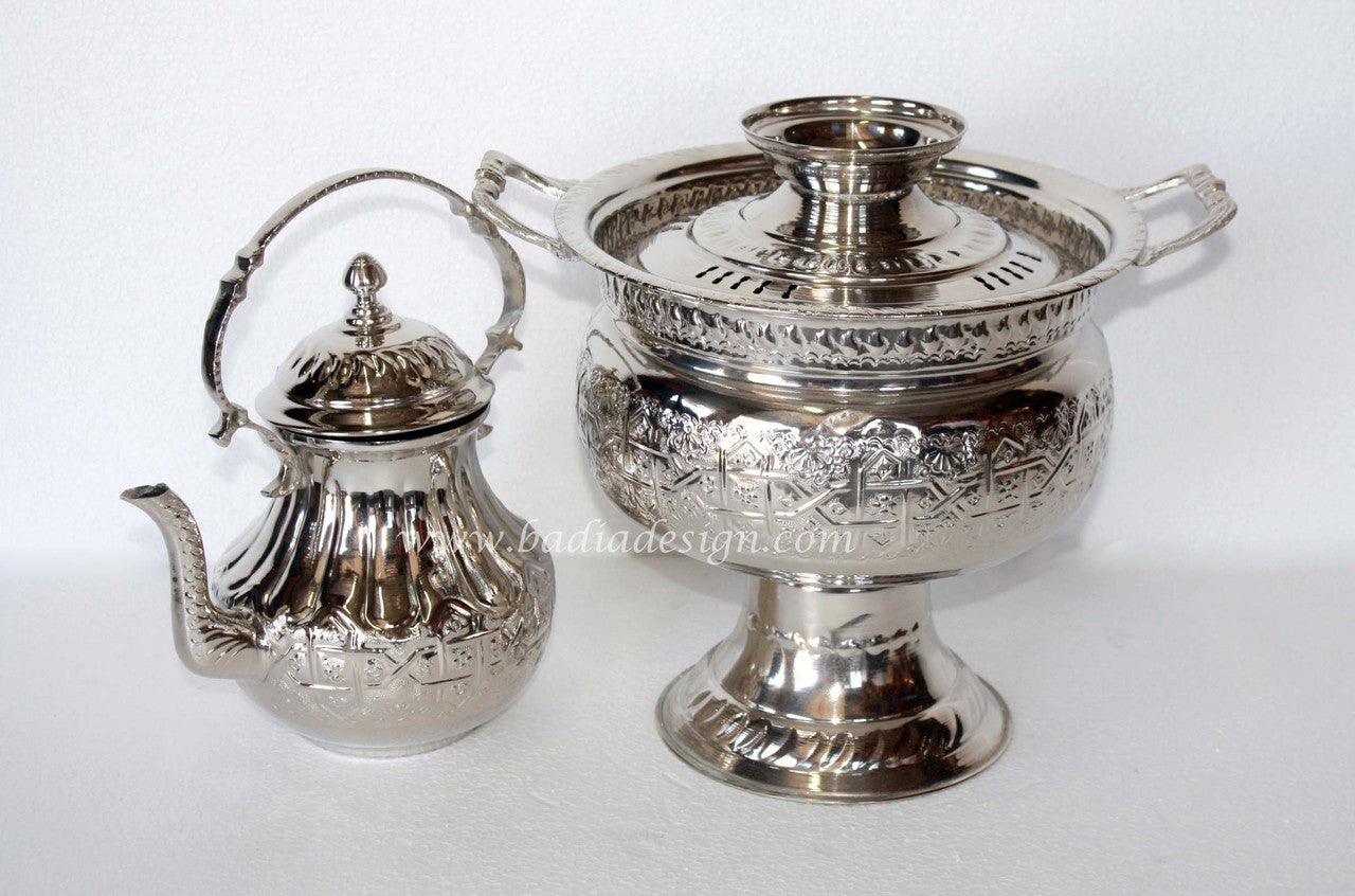 Silver teapot and sugar bowl set on a white background