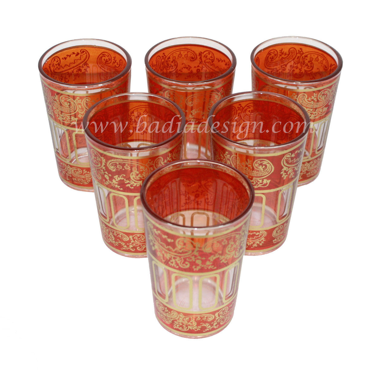 Set of six red glass tea cups with gold patterns on a white background