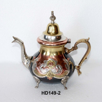 Decorative teapot with intricate designs on a white background