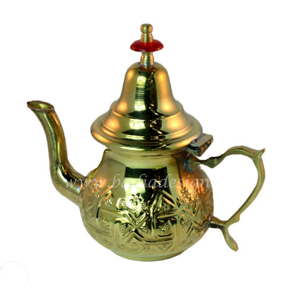 Gold teapot with intricate designs on a white background