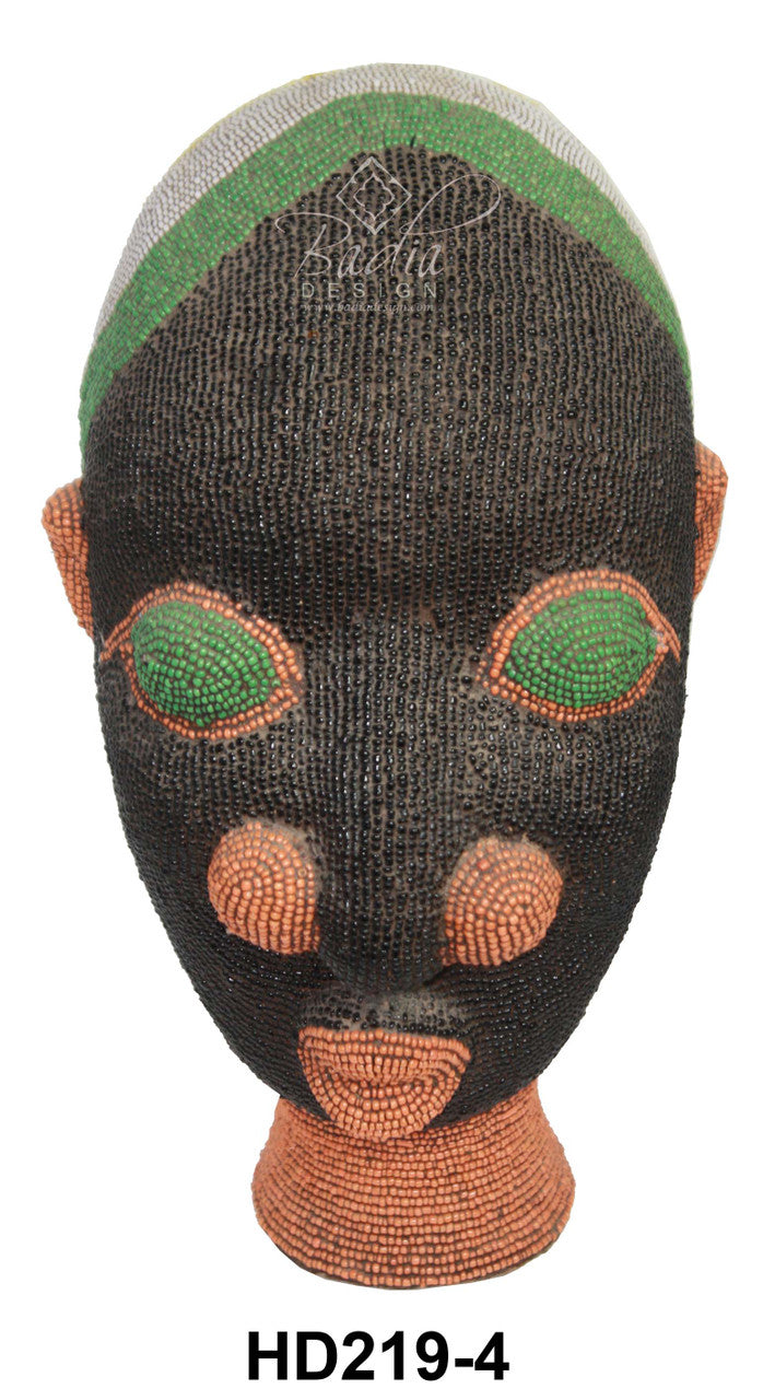 Decorative mask with green and orange accents on a white background