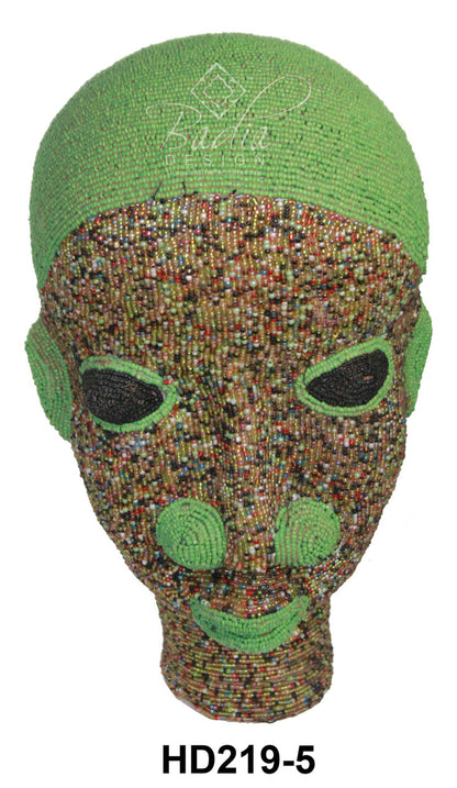 Decorative mask with green top and multicolored face on a white background