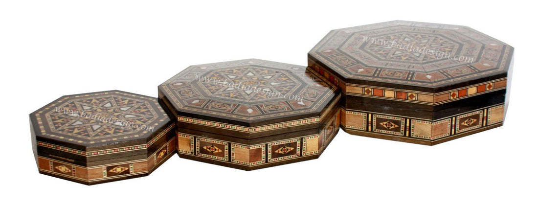 Set of three octagonal decorative boxes with intricate designs on a white background