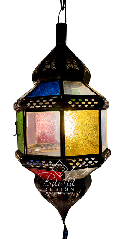 A hanging Moroccan-style lantern with a black metal frame and colorful stained glass panels, including blue, green, yellow, and pink sections, shown against a white background.