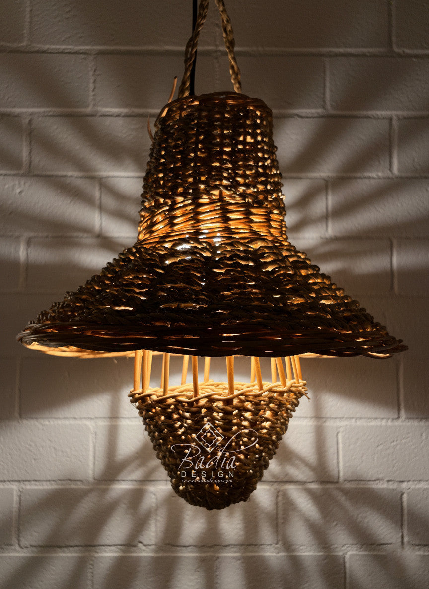 Woven pendant light hanging against a textured wall
