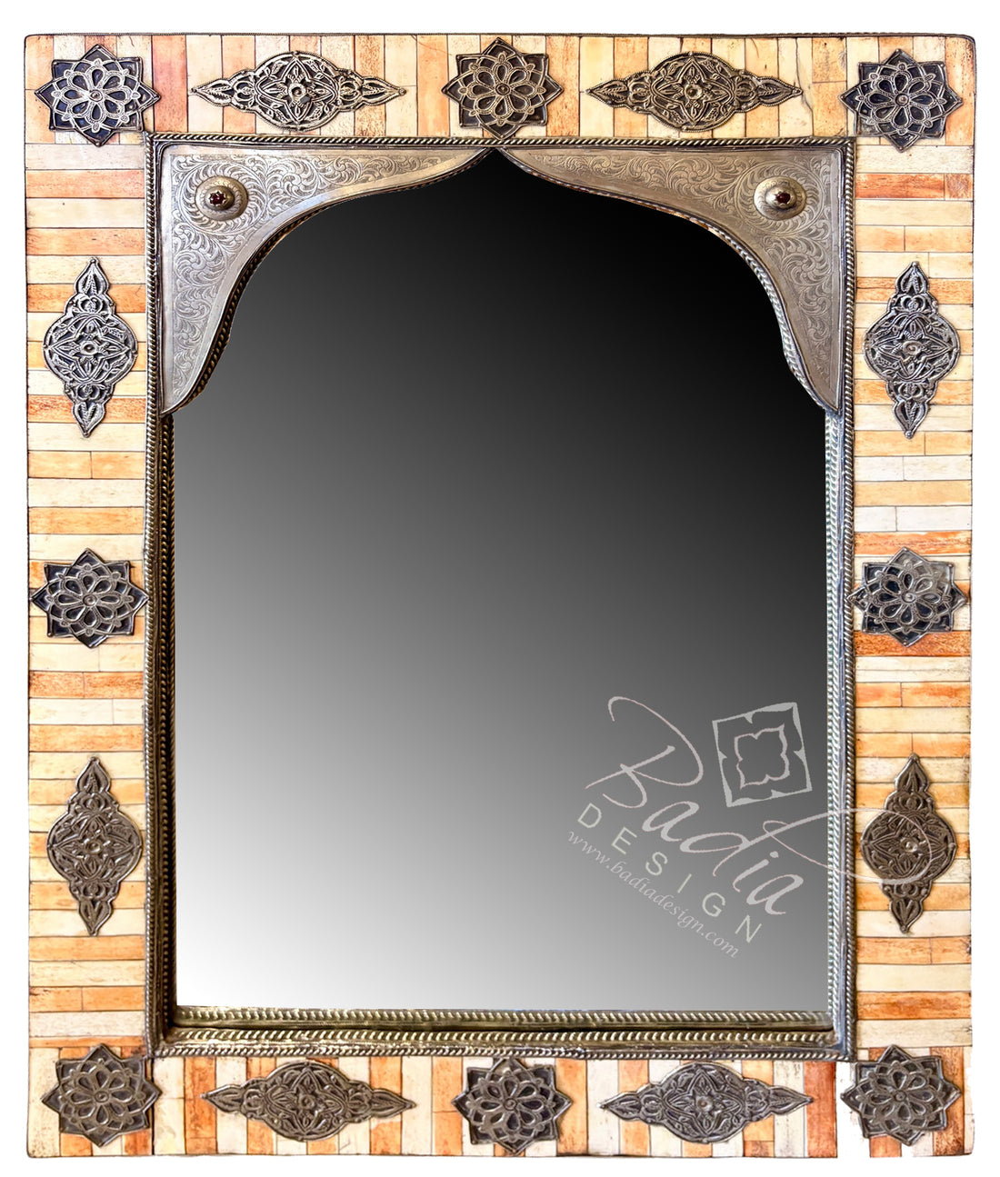 An ornate rectangular wall mirror with a decorative frame made of light wood and dark metal accents. The frame features intricate carved and embossed geometric patterns around the border and a scalloped metal top section.