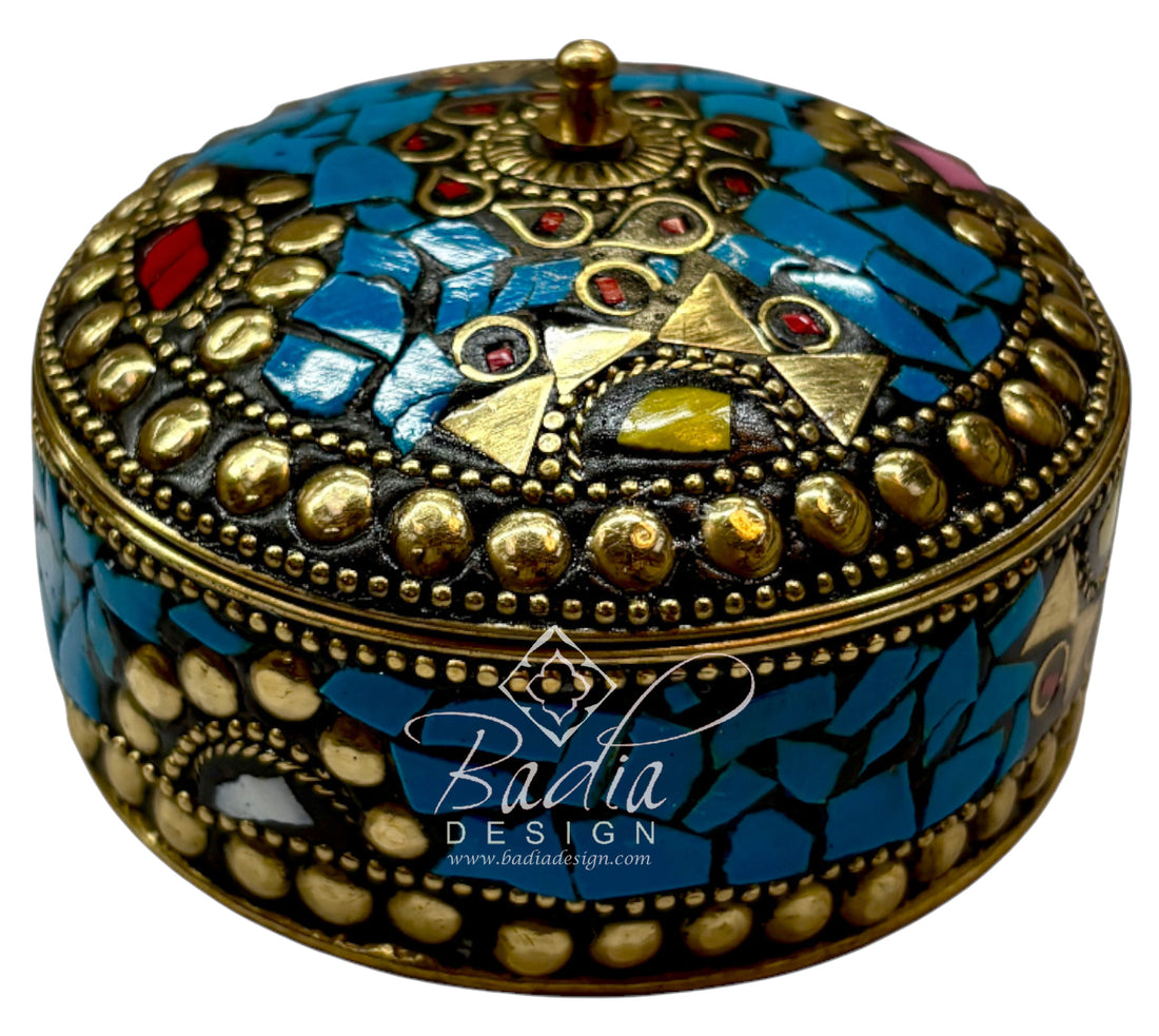 Decorative jewelry box with mosaic design and gold accents, featuring the Badia Design logo.
