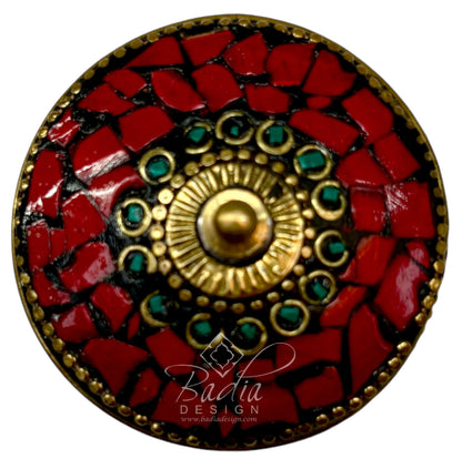 Decorative circular container top with red mosaic and gold and green central design, branded &