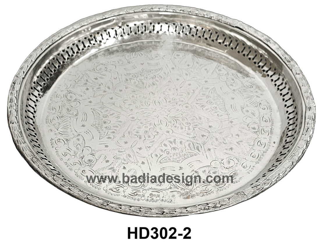 Decorative silver tray with intricate patterns on a white background, featuring the brand &
