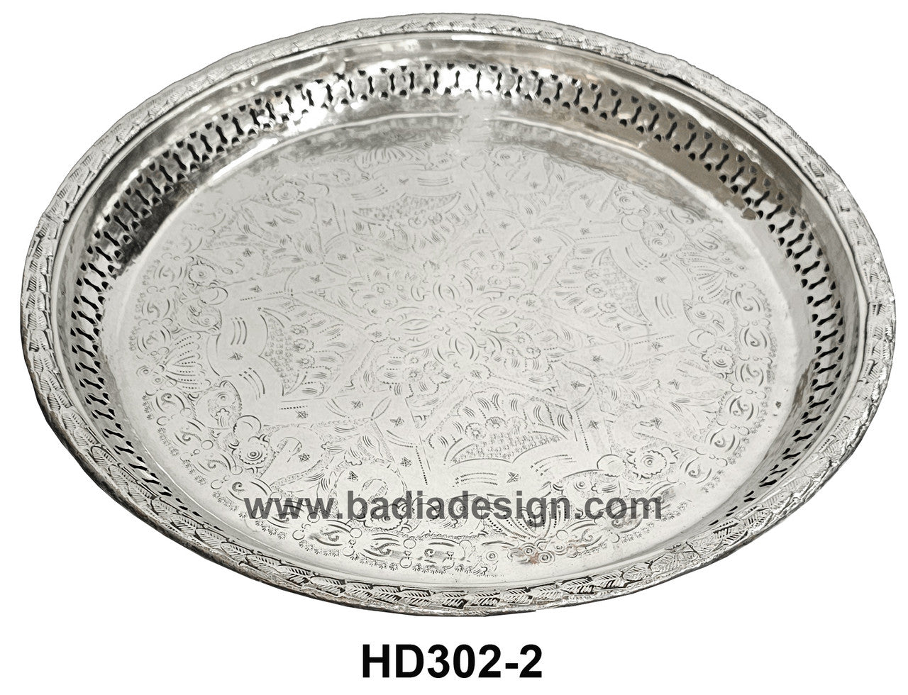 Decorative silver tray with intricate patterns on a white background, featuring the brand &