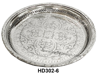 Decorative silver tray with intricate patterns on a white background