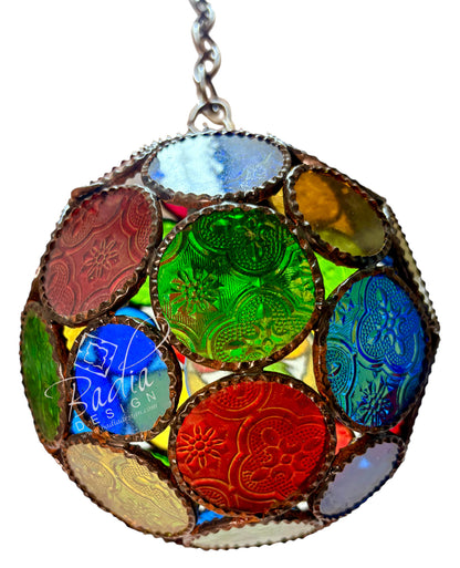 A spherical stained-glass style hanging ornament with multiple colored circular panels in blue, green, red, yellow, and purple, outlined in metallic gold-toned edging, shown against a white background.