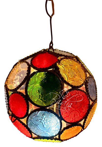 A hanging stained-glass style decorative light or ornament with a circular frame made of multiple colored glass panels including red, green, blue, yellow, orange, and clear sections separated by dark metal outlines, shown on a white background.