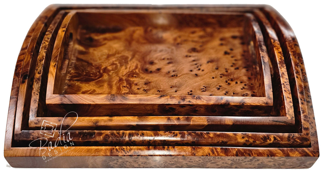 Set of three wooden trays with a burl pattern on a white background
