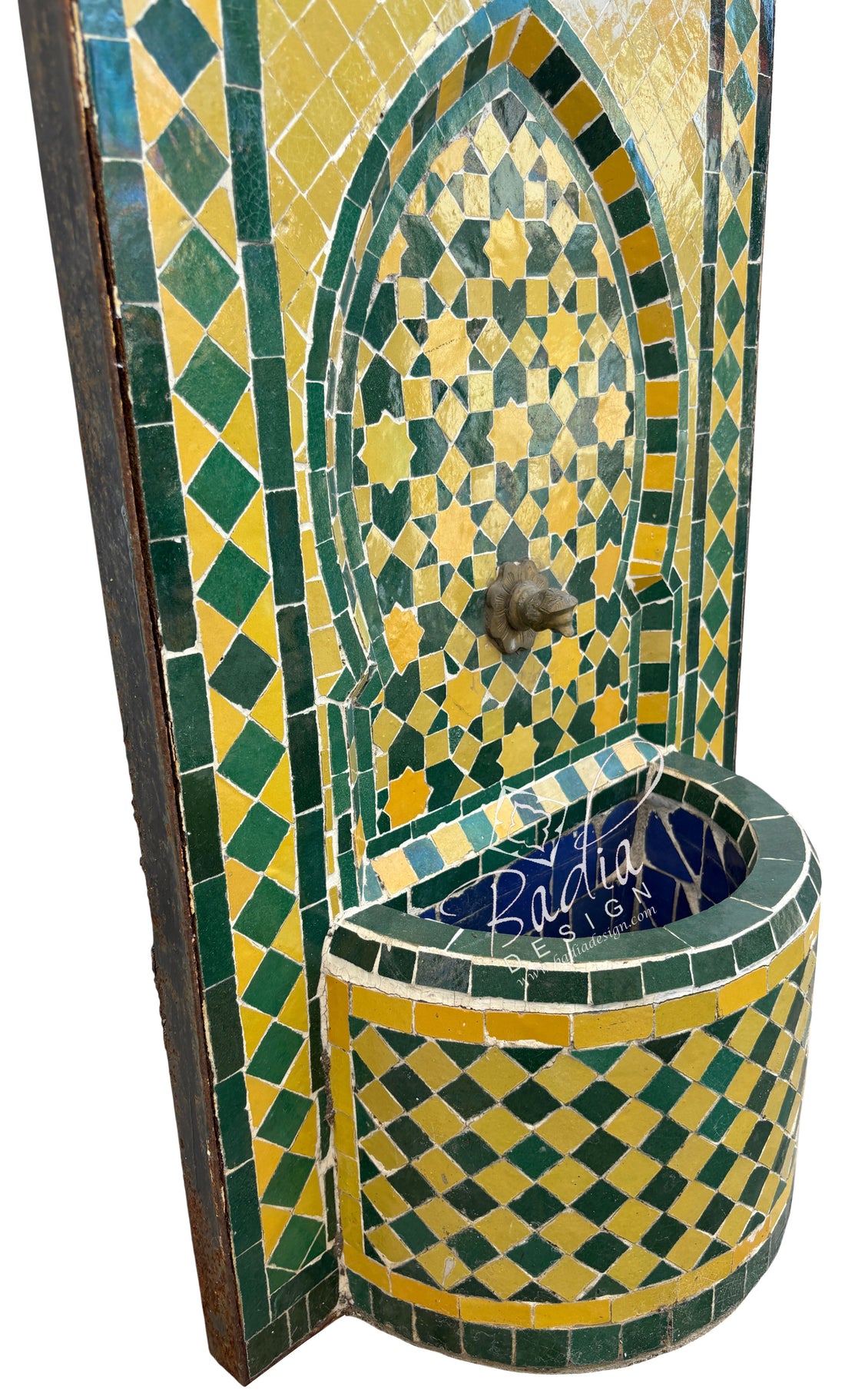 Decorative mosaic fountain with geometric patterns in green, yellow, and blue.