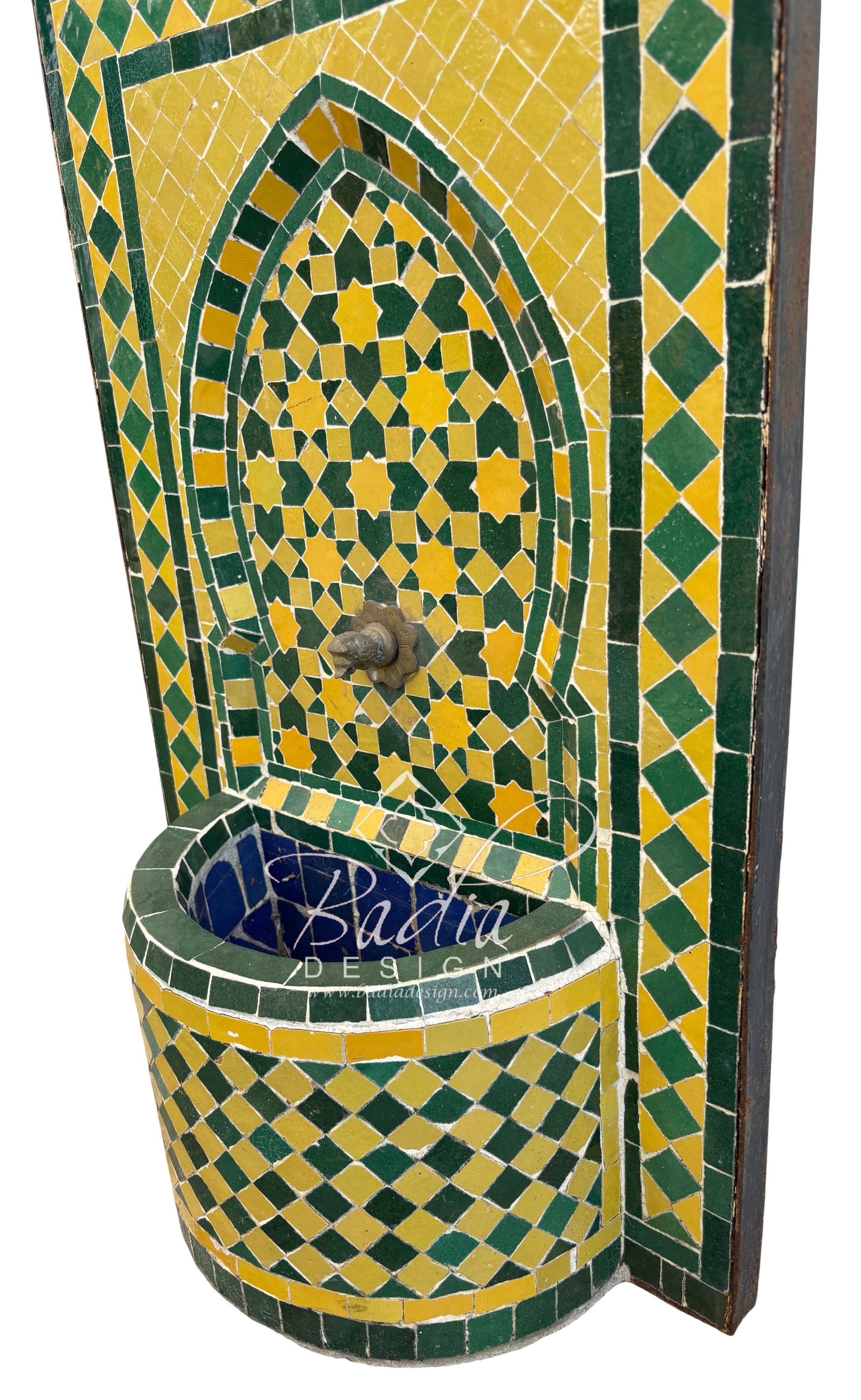 Decorative mosaic fountain with green and yellow patterns on a white background