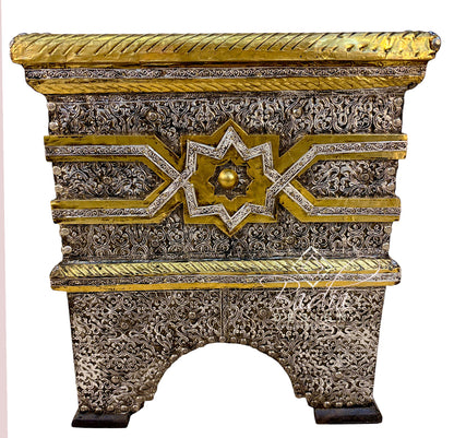 An ornate rectangular decorative chest or cabinet with intricate silver filigree carvings and gold accents, featuring a star motif on the front and a rope-textured top edge, shown against a plain white background.