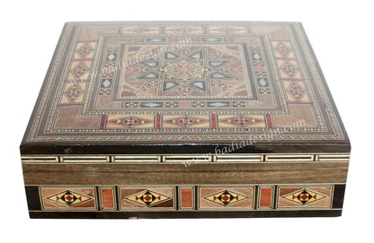 Decorative wooden box with geometric patterns on a white background