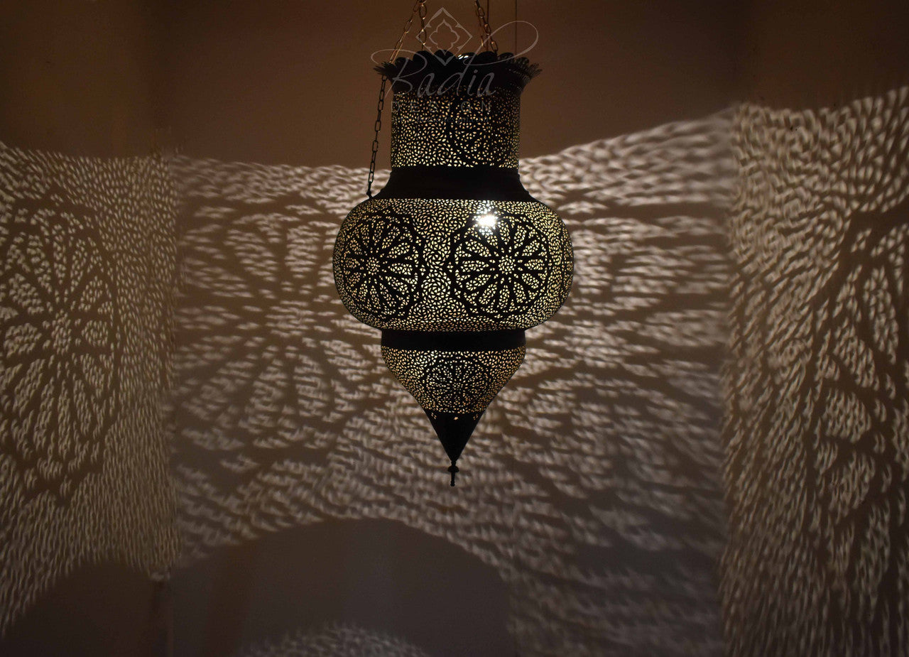 Decorative hanging lantern casting shadows on a textured wall
