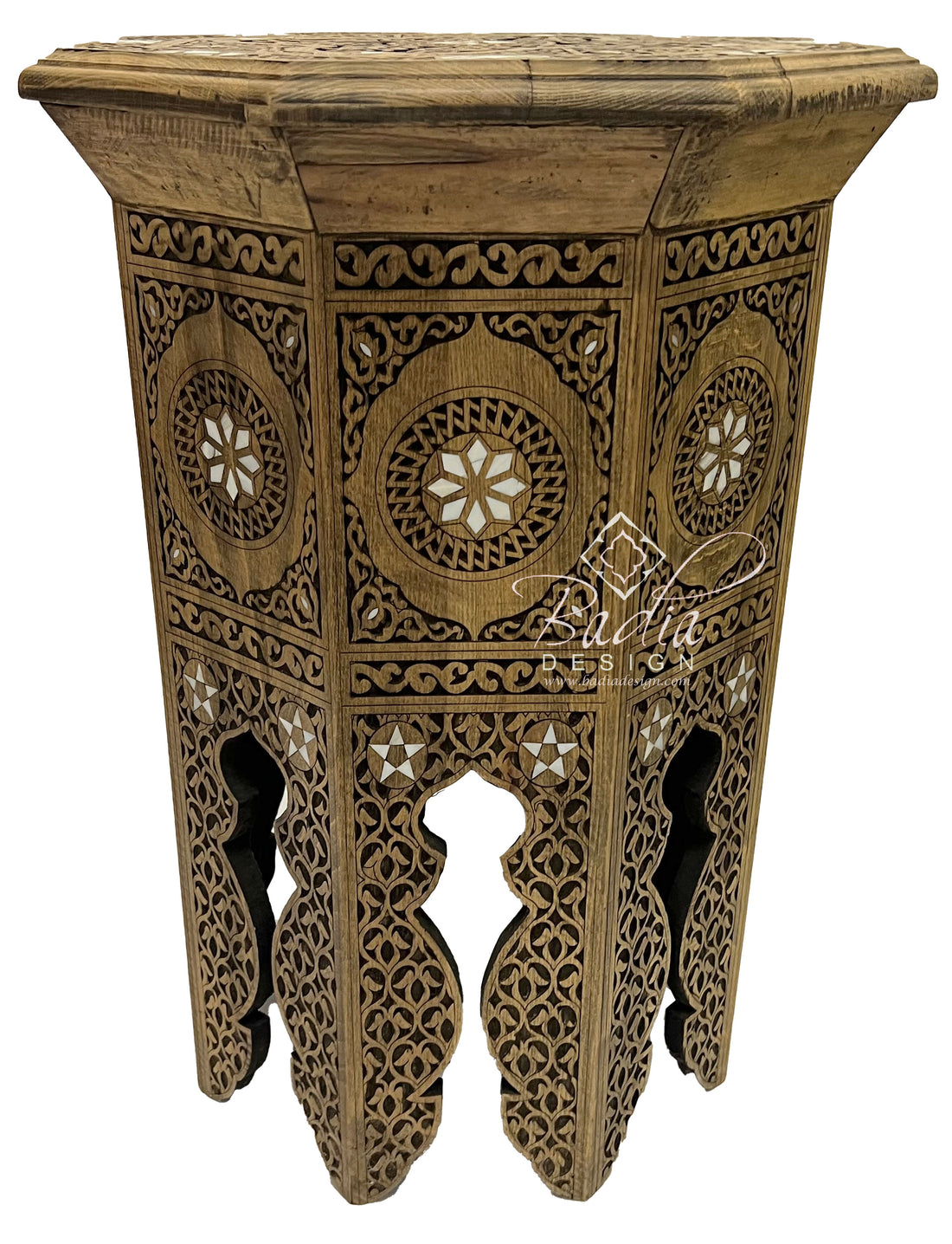 Decorative wooden side table with intricate carvings on a white background