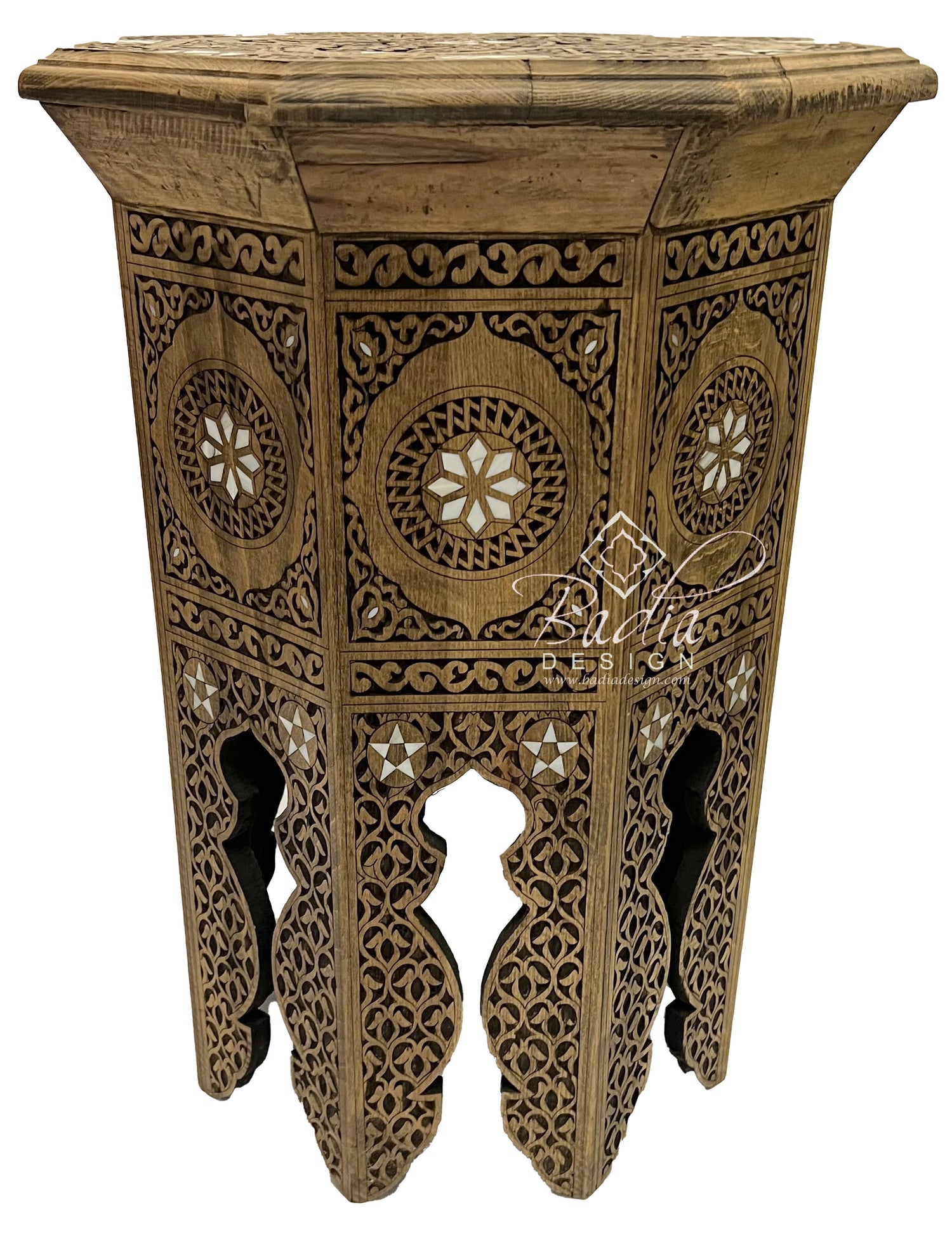 Decorative wooden side table with intricate carvings on a white background