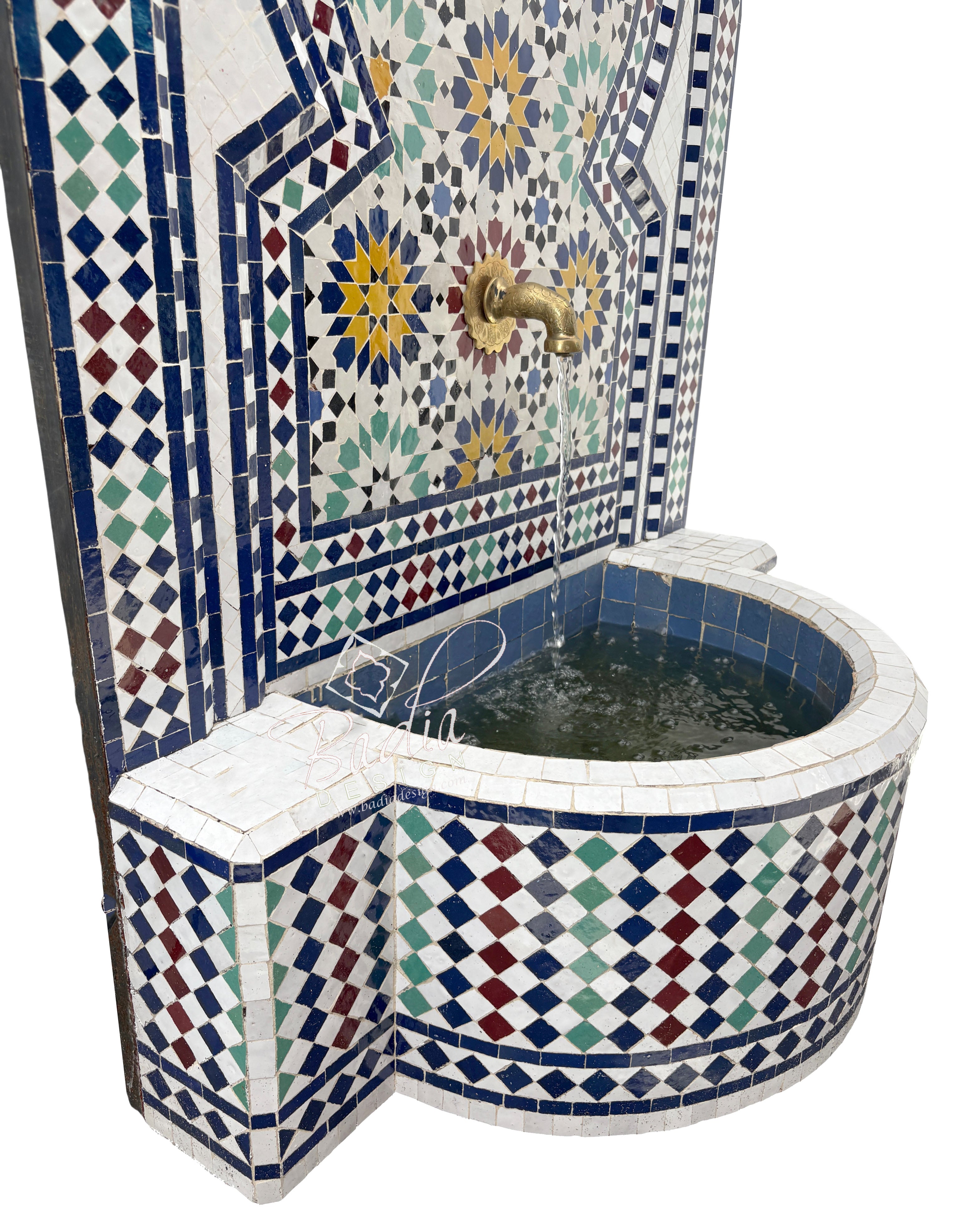 Mosaic-tiled corner bathtub with decorative patterns on a white background