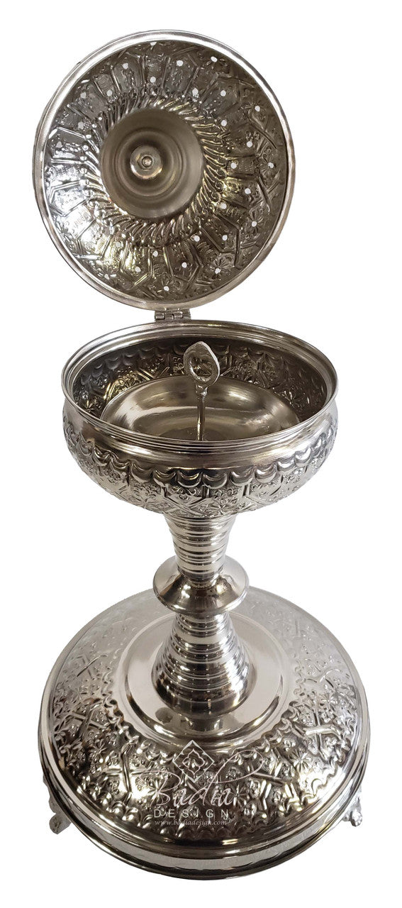 Decorative silver censer with intricate designs on a white background