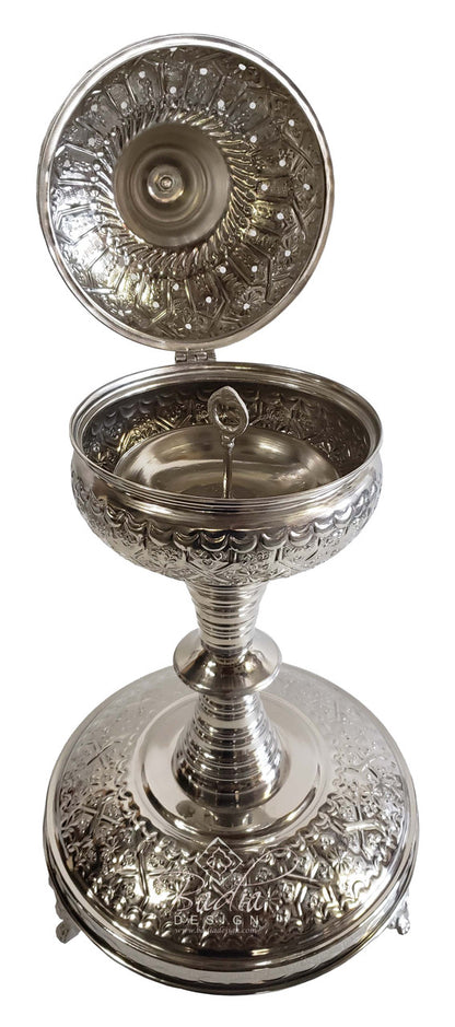 Decorative silver censer with intricate designs on a white background