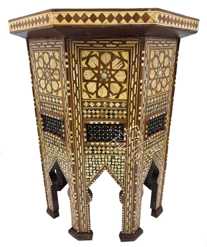 Decorative wooden side table with intricate patterns on a white background