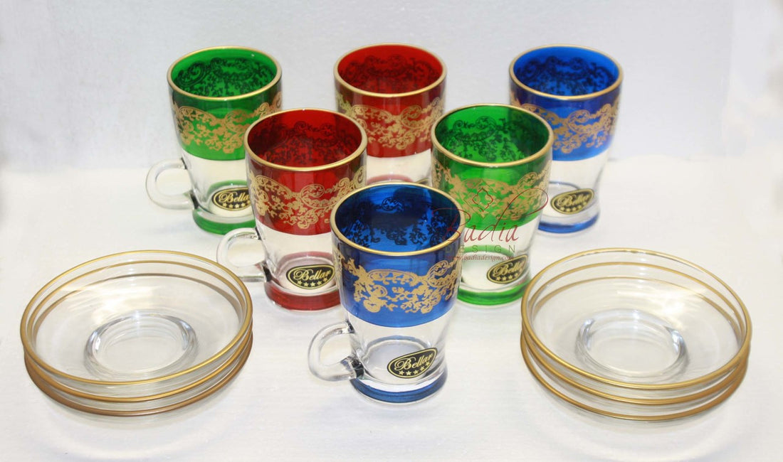 Set of colorful glass tumblers with gold accents on a white background