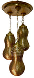 A brass three-light pendant chandelier with textured, hammered metal globes hanging from a round ceiling canopy, shown against a plain white background.