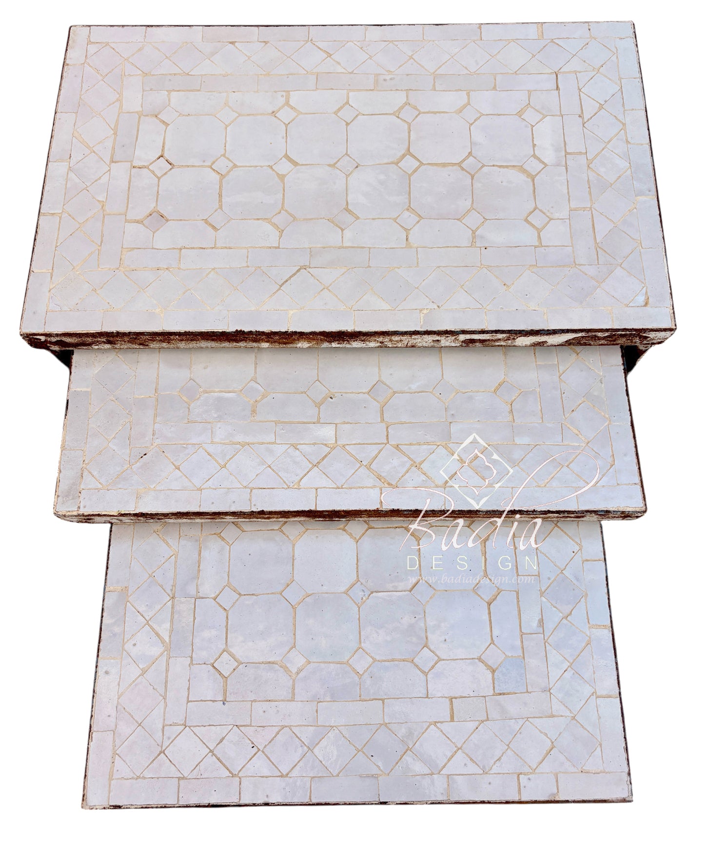 Three rectangular nesting tables stacked vertically, featuring a white mother-of-pearl inlay with a geometric pattern and gold-toned accents, set against a plain white background.
