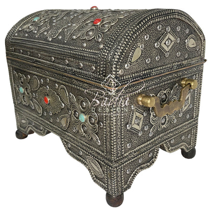 Decorative silver jewelry box with intricate designs and gemstones on a white background