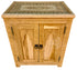 A light natural wood cabinet with intricate hand-carved geometric and floral patterns, featuring two doors with dark metal ring pulls and hinges, set against a plain white background.