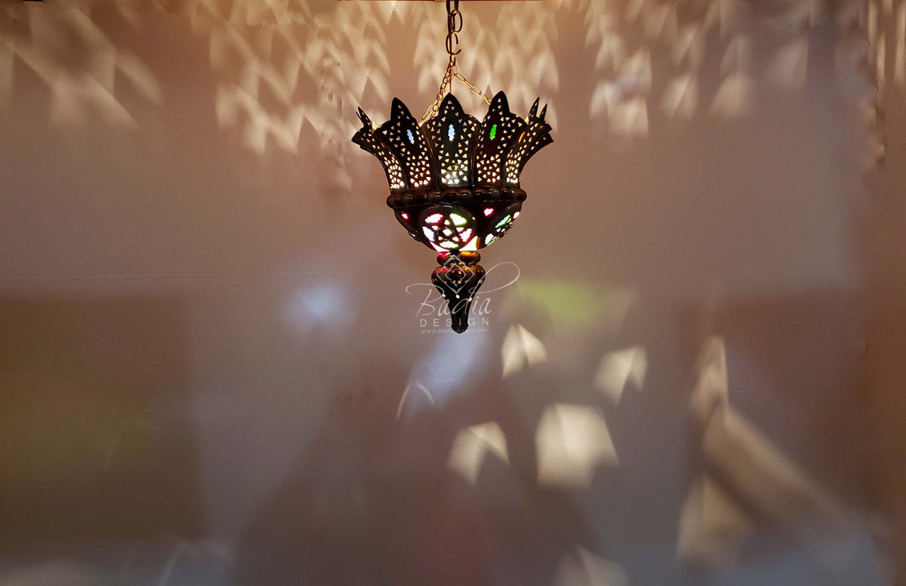 Decorative hanging lamp with intricate design against a blurred background