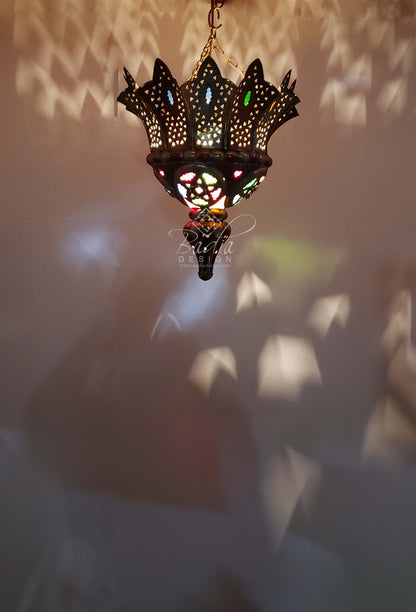 Decorative hanging lamp with intricate design on a soft background