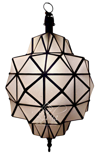 A geometric pendant light fixture with a faceted, geodesic design made of cream-colored panels and black metal framing, suspended against a plain white background.