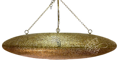 A large, oval-shaped hanging pendant light with a textured, hammered metallic gold finish, suspended by chains against a plain white background.