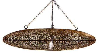 A large oval hanging pendant light with a gold-toned metal frame covered in intricate black floral or filigree cutouts, suspended by chains against a plain white background.